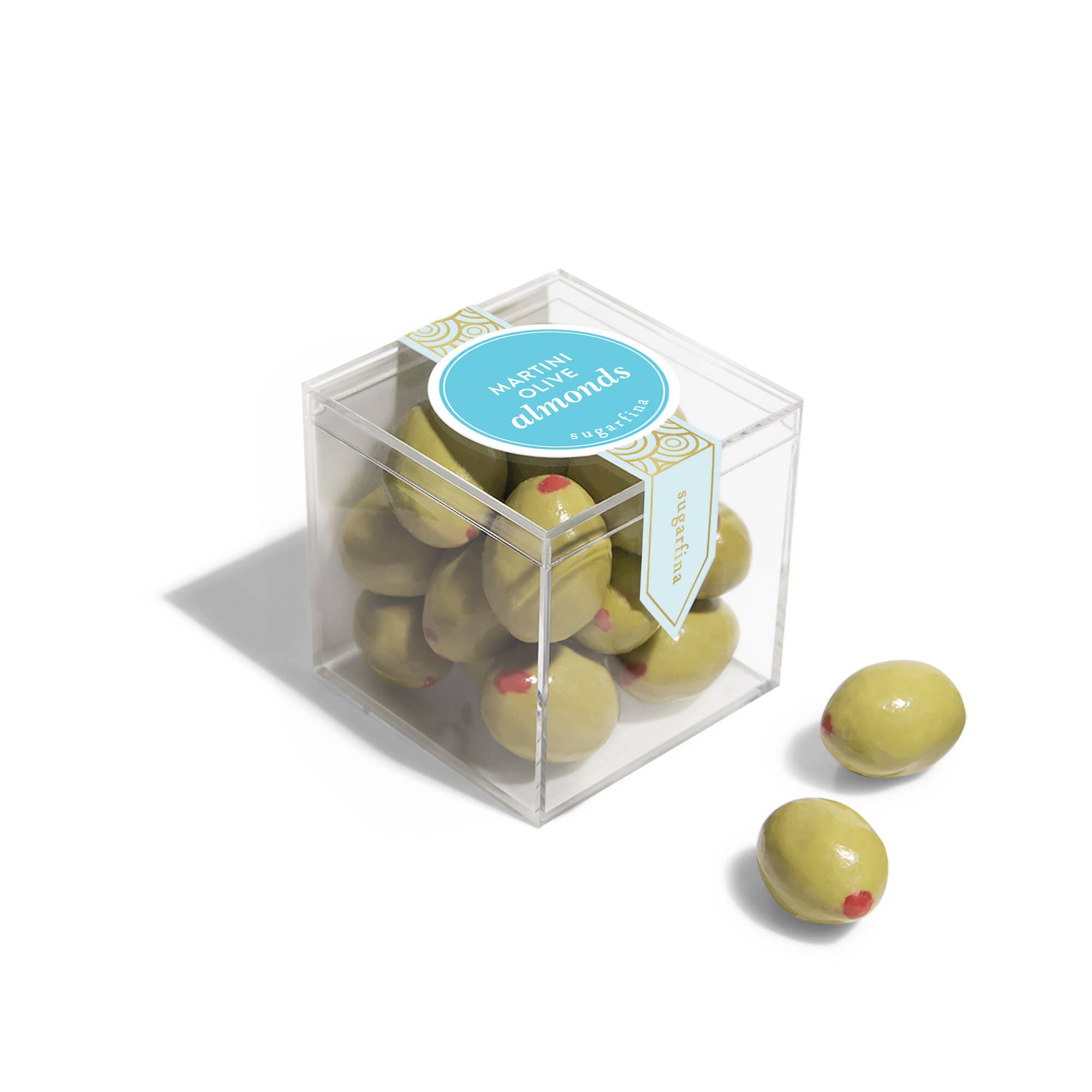 Green chocolate almonds in a clear cube box with a blue label on a white background
