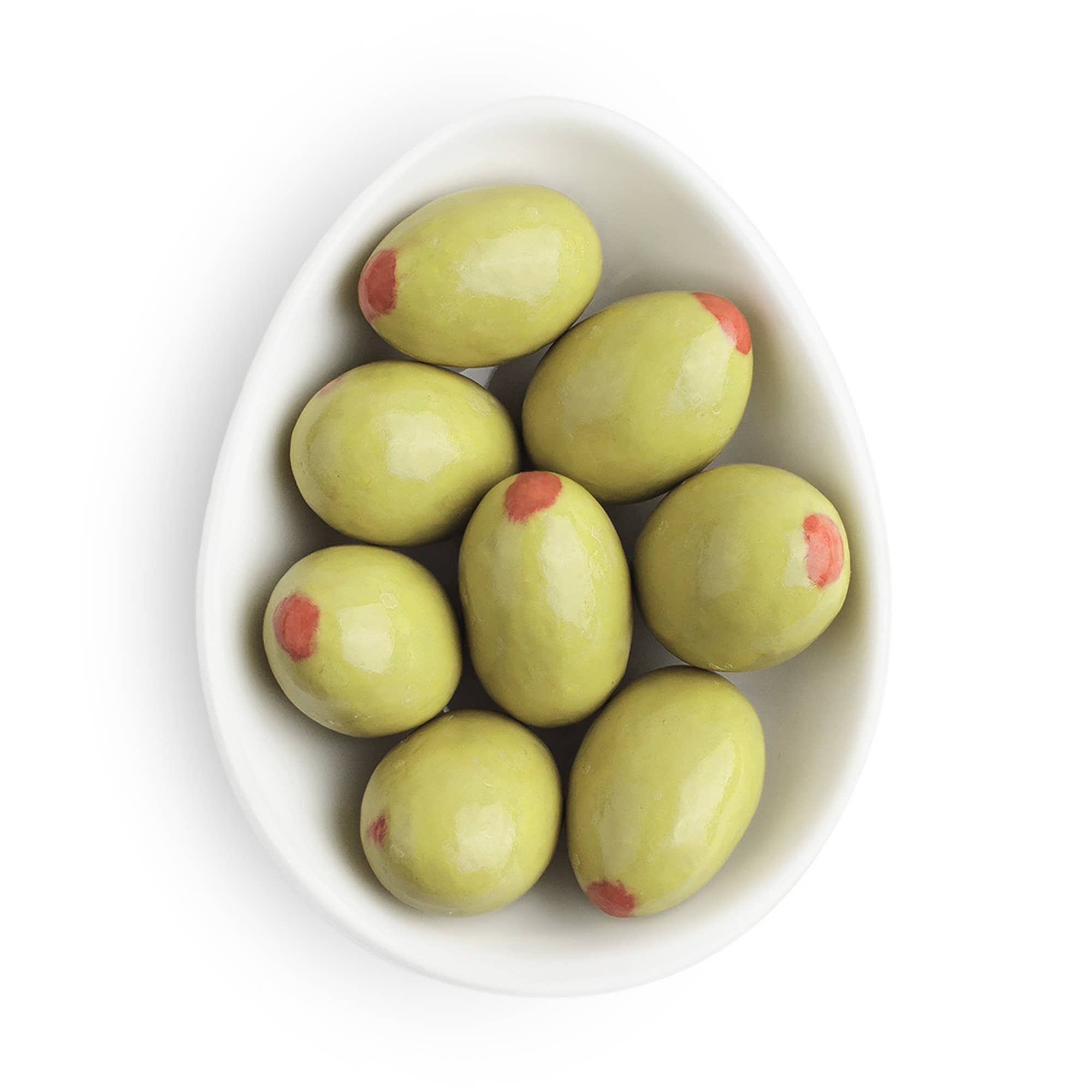 Green almonds with red spots in a white bowl on a white background