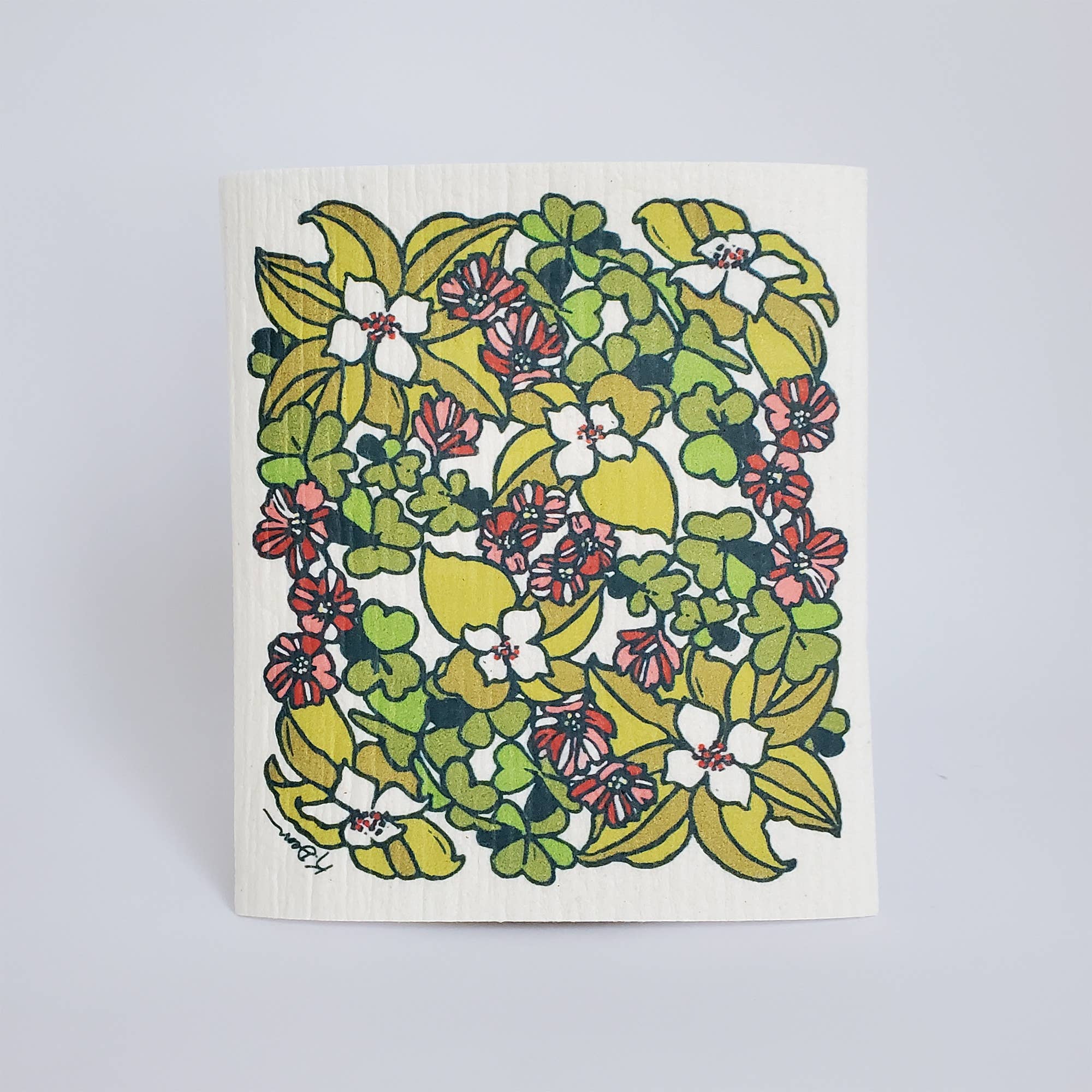 Floral patterned dishcloth on a light gray background