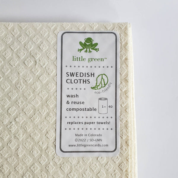 Swedish cloth with 'little green' label on a textured beige background