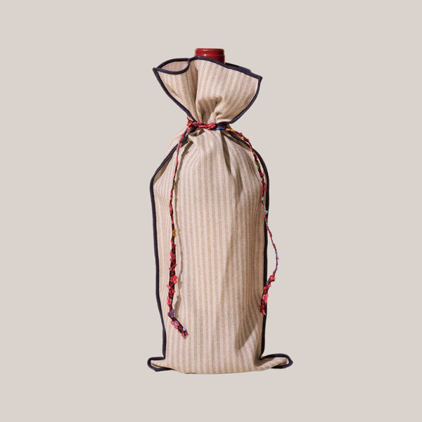 Beige wine bottle cover with black trim and red accents on a beige background