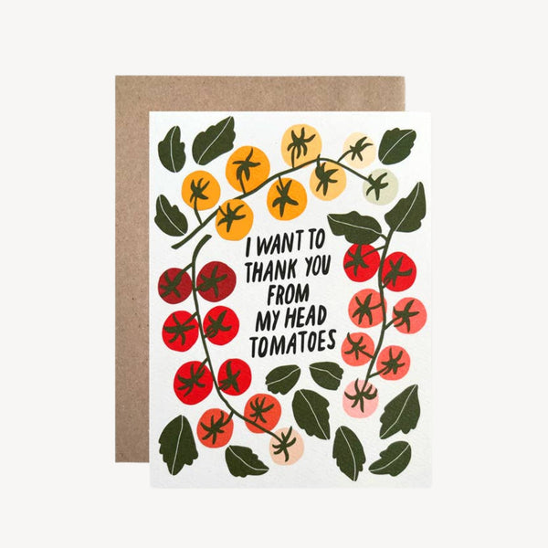 A white greeting card with a brown kraft envelope behind it, featuring an illustration of tomatoes and the text 'I WANT TO THANK YOU FROM MY HEAD TOMATOES'.