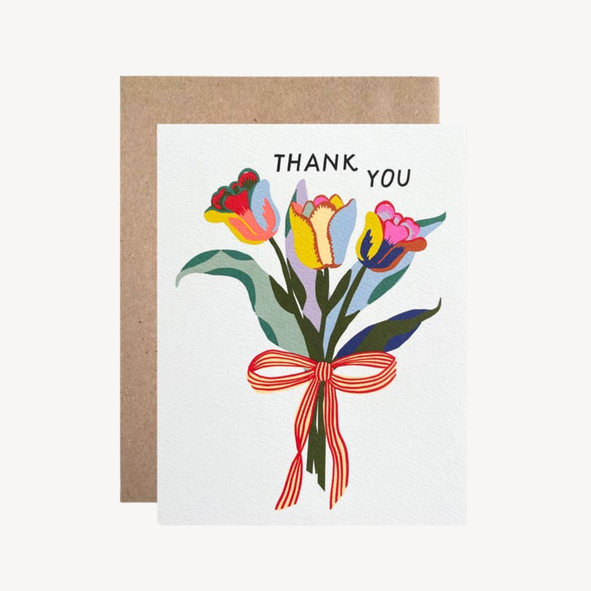 A square thank-you card with a kraft envelope behind it, featuring an illustrated bouquet of tulips in pink, yellow, blue, and green with the words “THANK YOU” above the flowers.