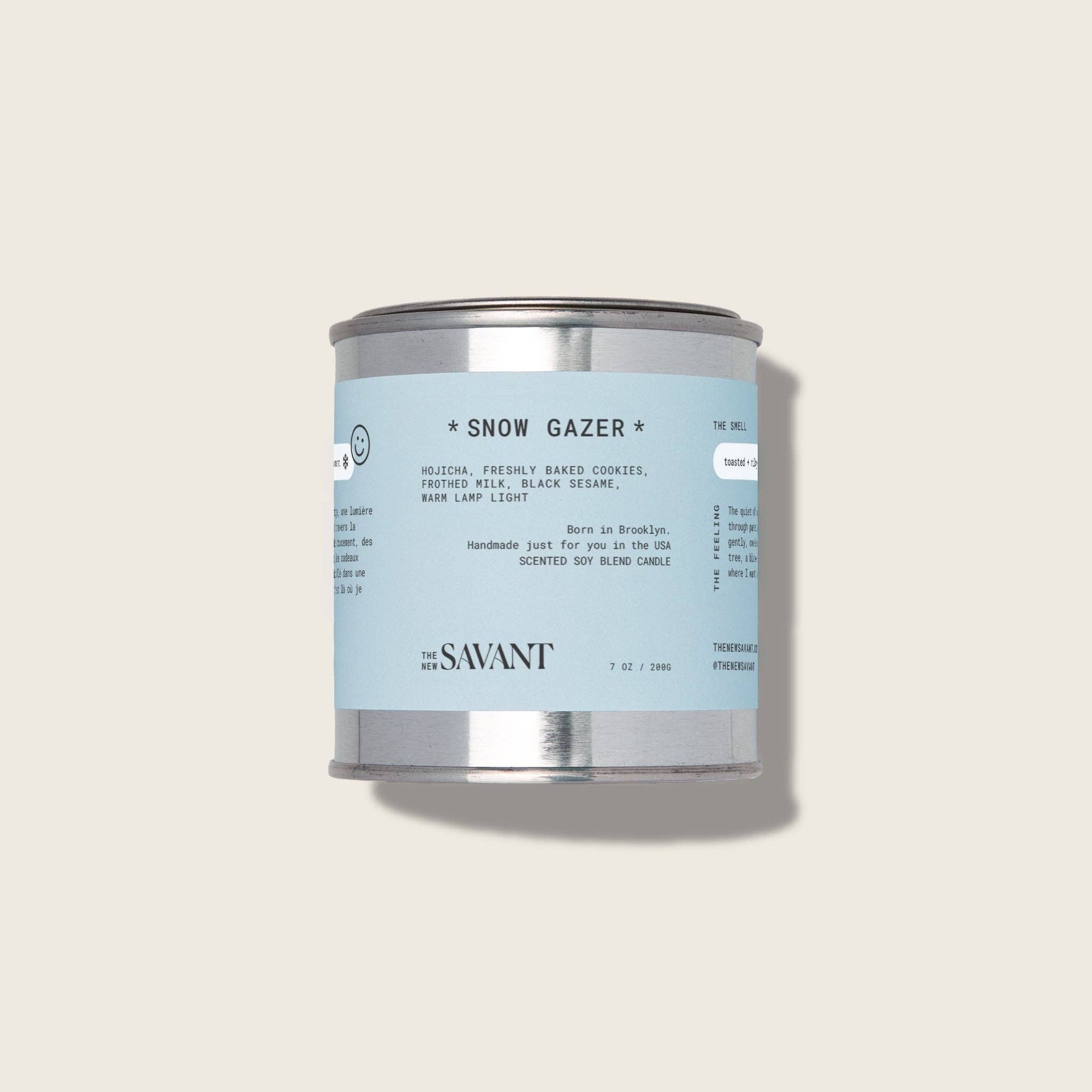Candle can labeled 'Snow Gazer' by The New Savant on a light gray background