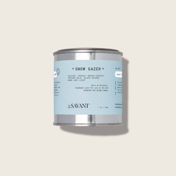 Candle can labeled 'Snow Gazer' by The New Savant on a light gray background
