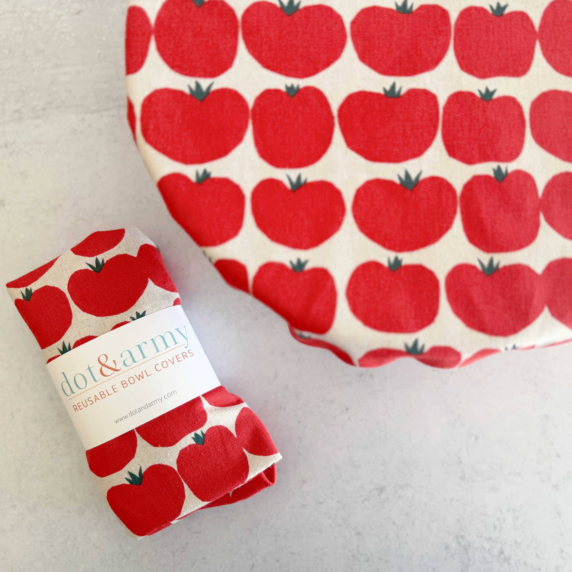 Red tomato-patterned bowl cover and packaging on a light background