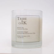 Candle with 'Tribe & Oak' label on a white background