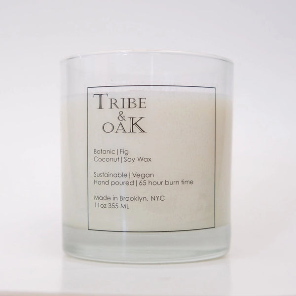 Candle with 'Tribe & Oak' label on a white background