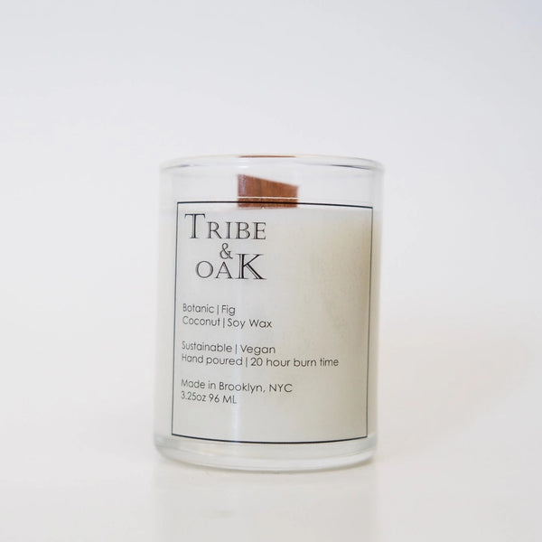 Candle with 'Tribe & Oak' label on a white background