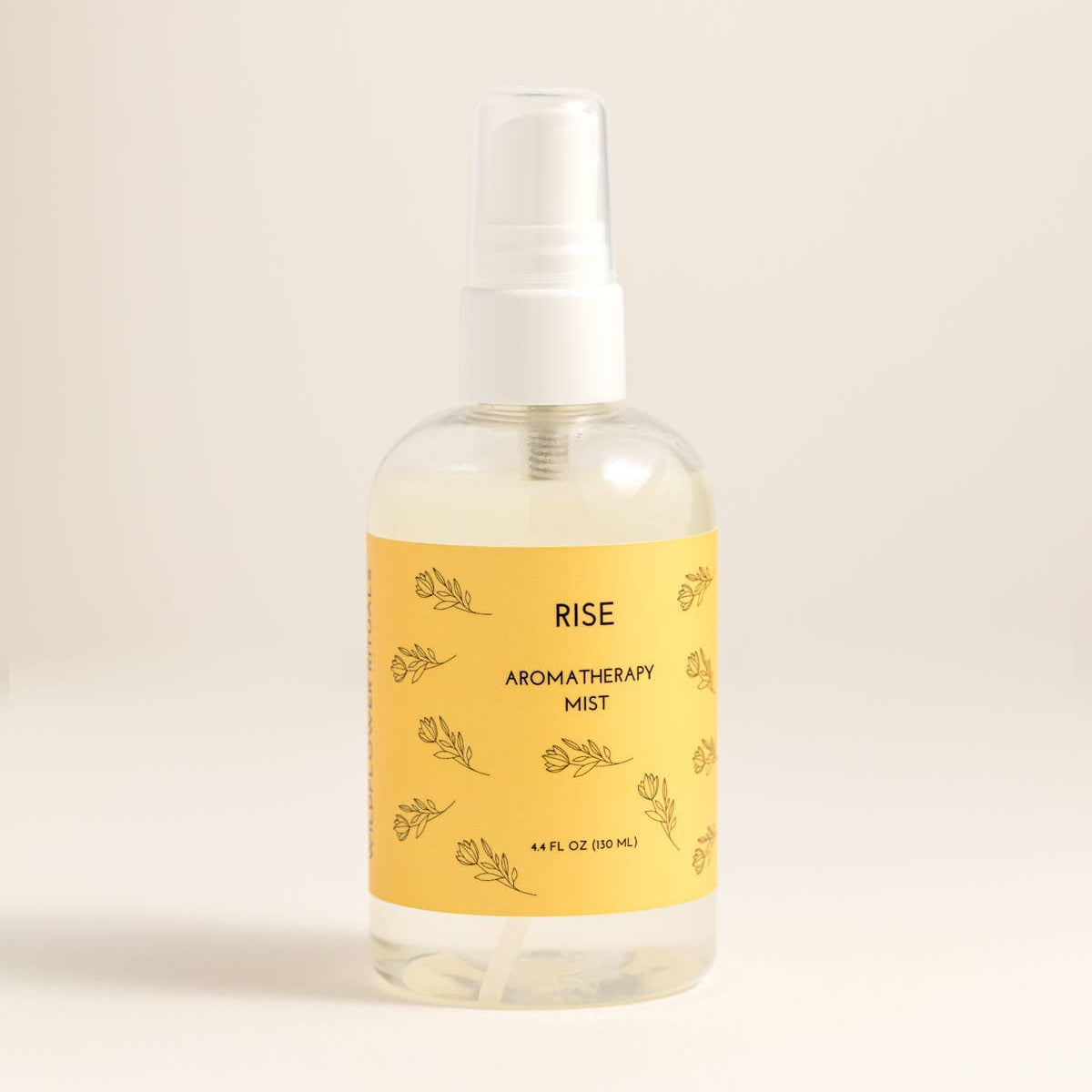 Aromatherapy mist bottle labeled 'Rise' on a beige background