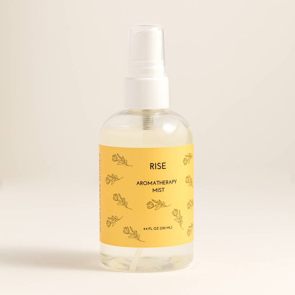 Aromatherapy mist bottle labeled 'Rise' on a beige background