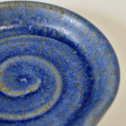Close-up of a blue ceramic dish with speckled pattern